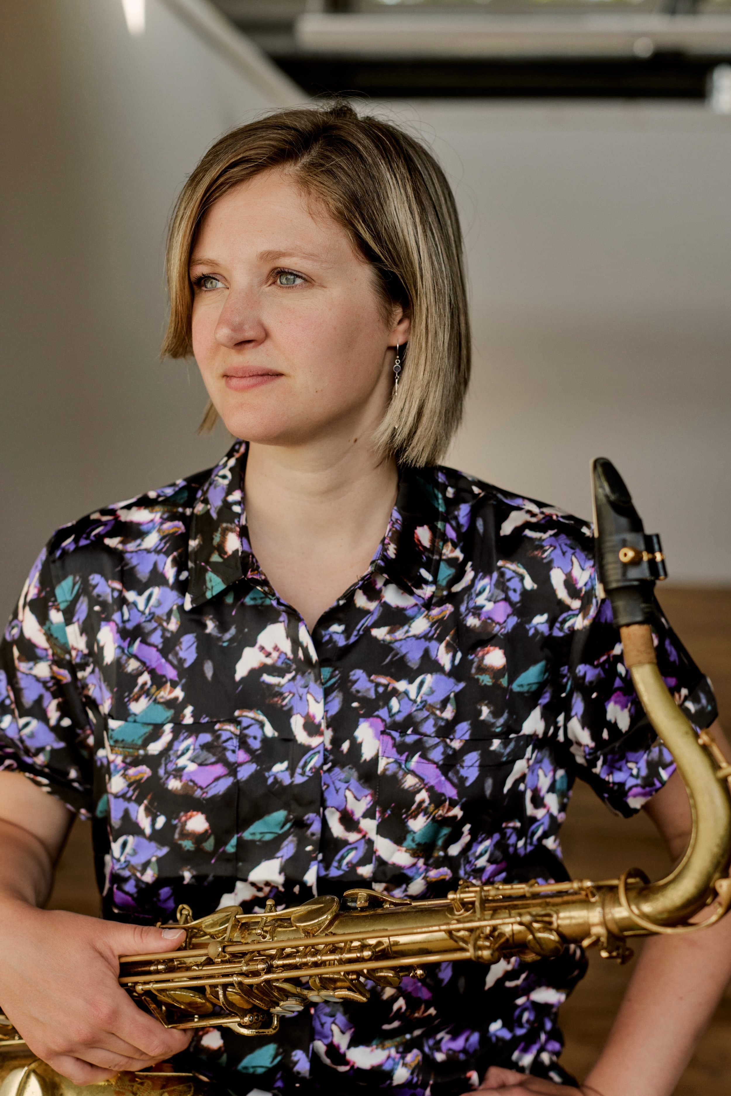 Claire Devlin performing with tenor saxophone